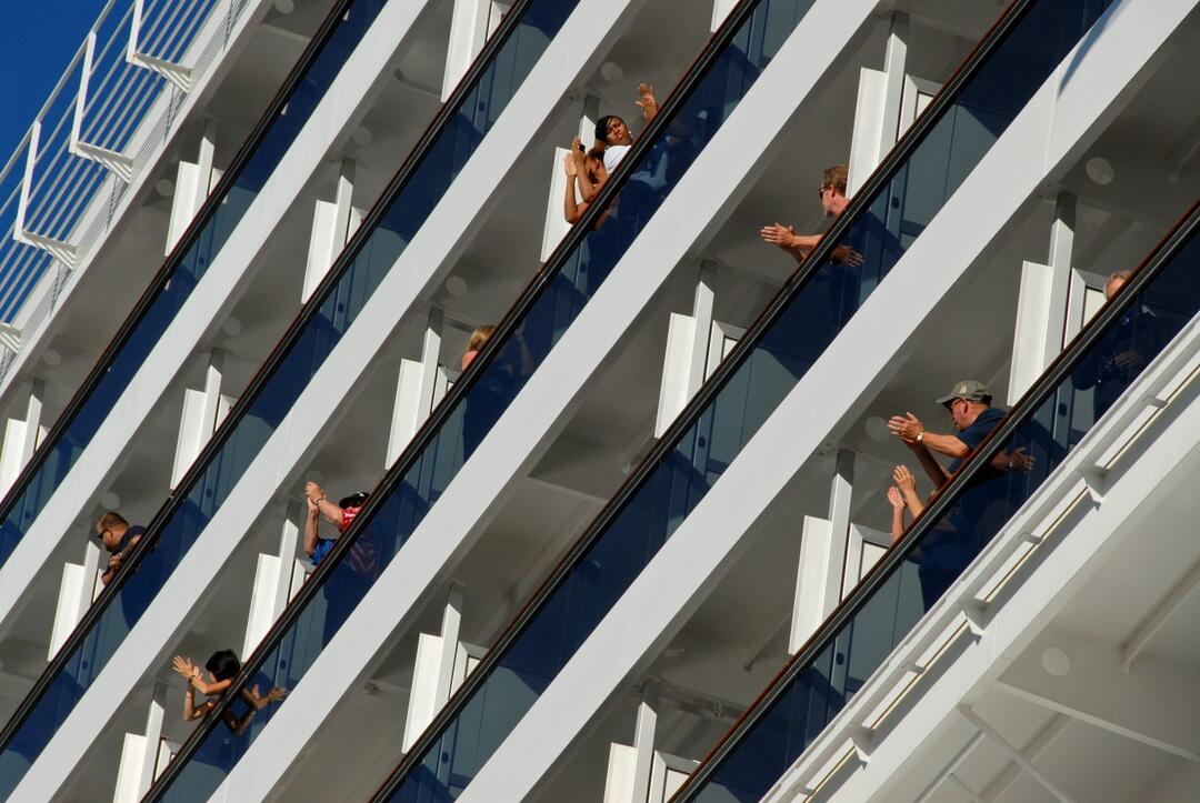 Cruise ship passengers wave from balconies at the Port of San Diego