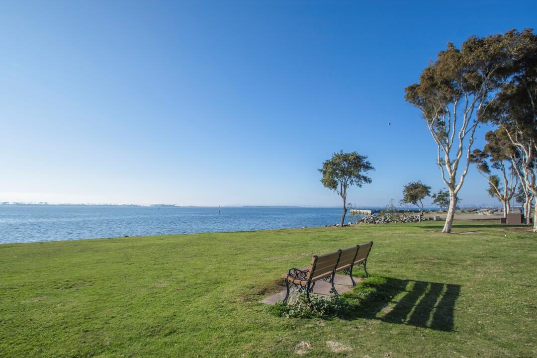 Bench on grass overlooking water at Chula Vista Bayside Park at the Port of San Diego