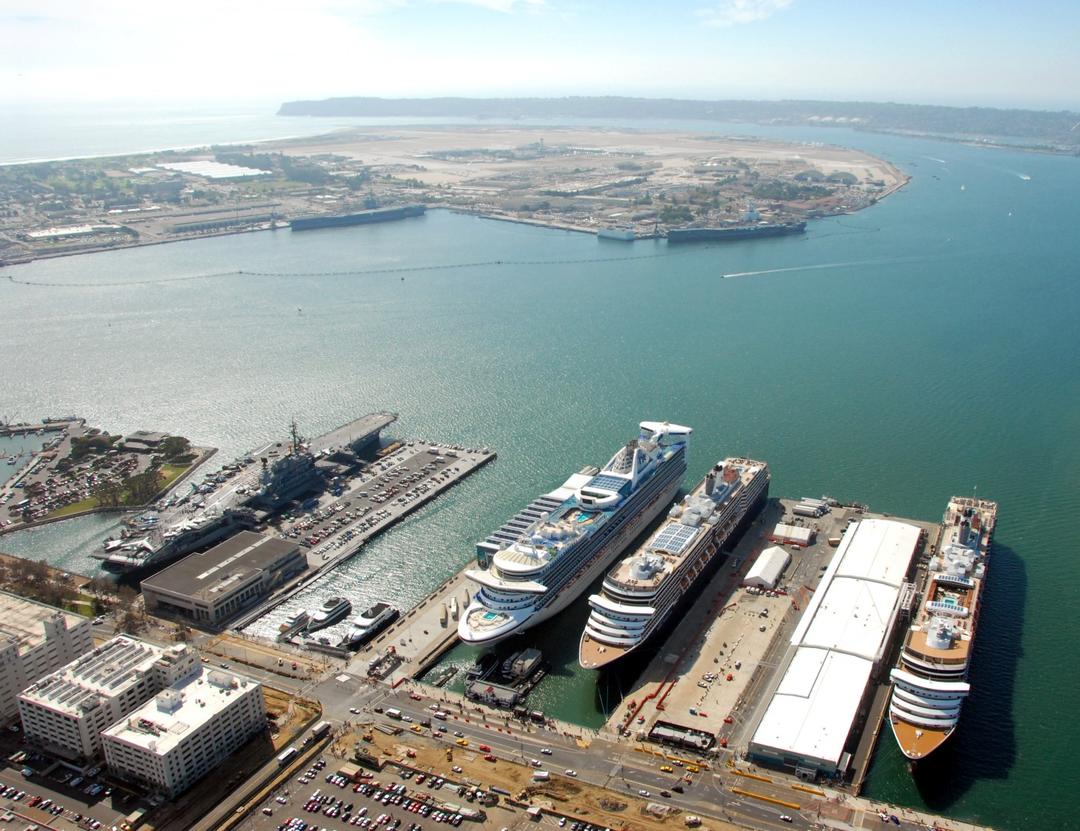 an aerial view of the San Diego Bay from above downtown San Diego looking at the cruise ship terminals over the water and towards Point Loma