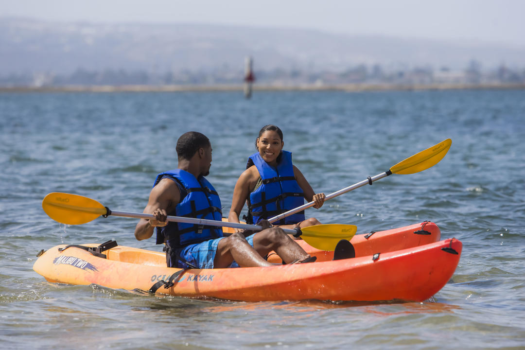 a couple paddles kayaks on the San Diego Bay