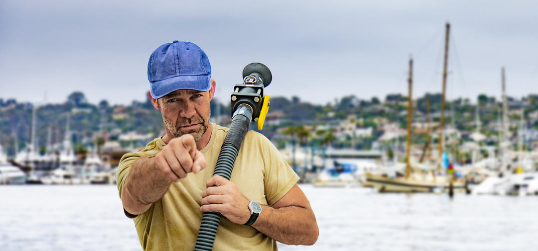 a person is holding a pump out hose and pointing at the viewer
