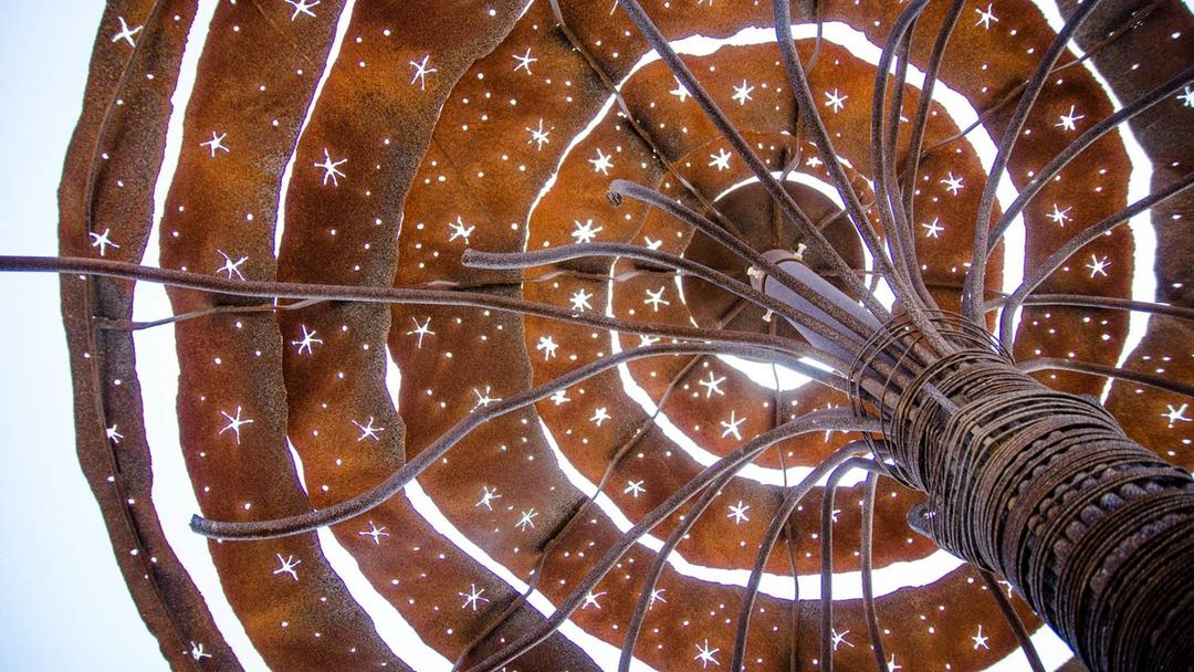 looking skyward through a rusty metal spiral