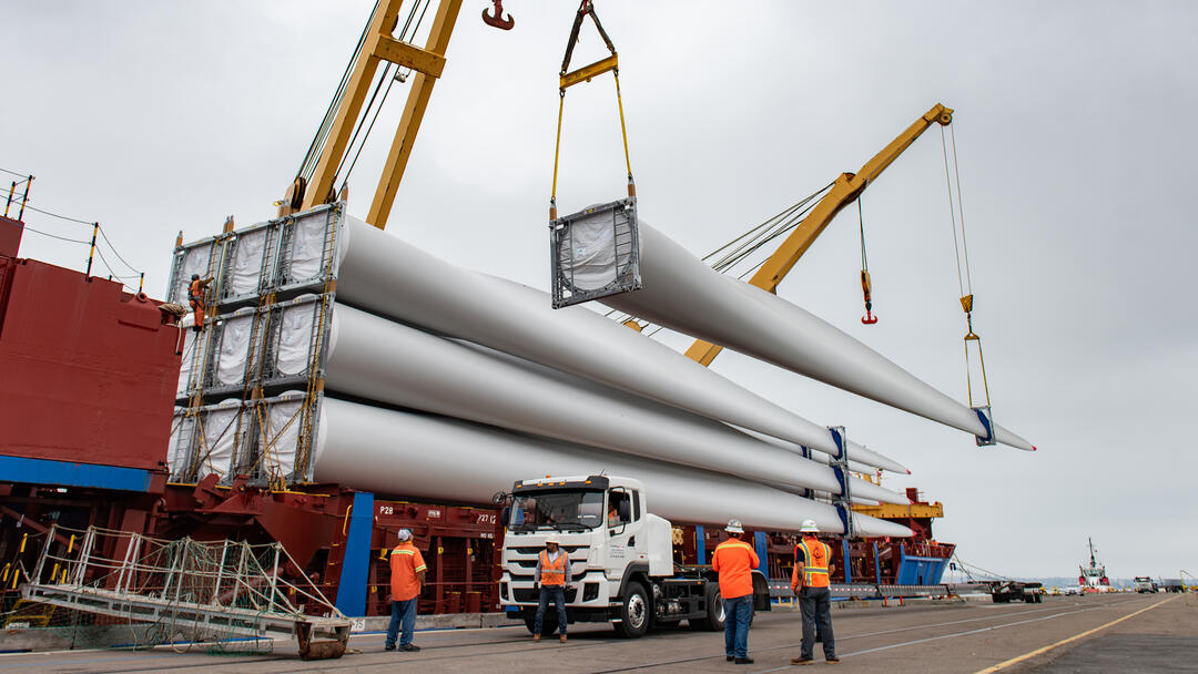 a cargo ship unloads 220 foot windmill blades at the Port of San Diego