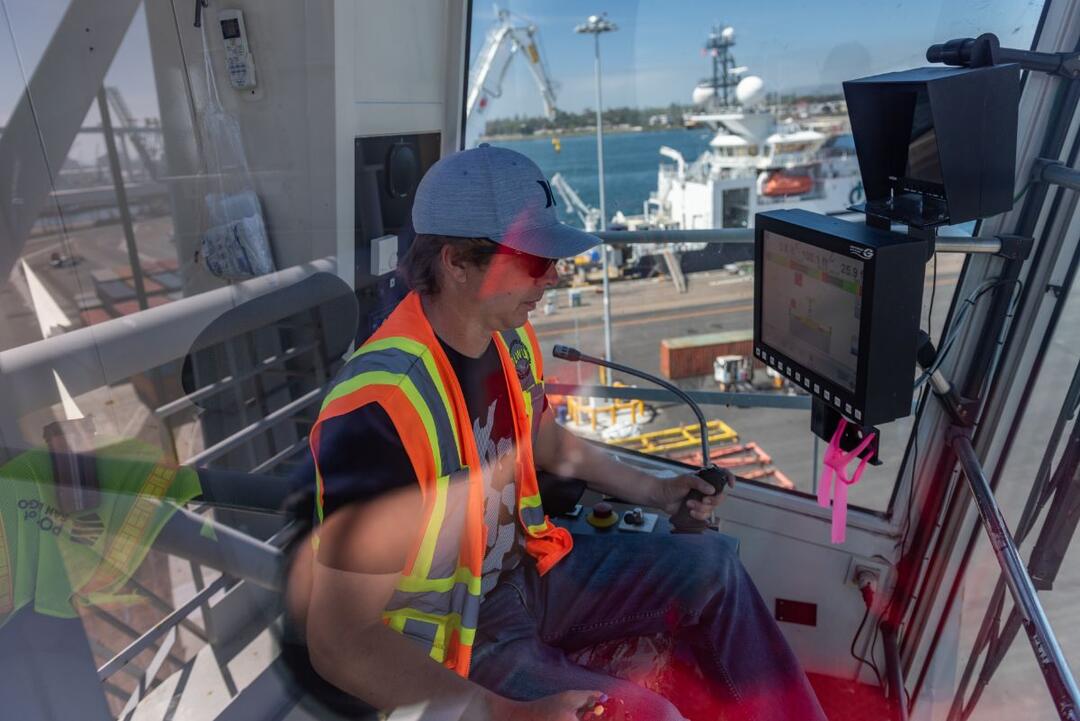 a man operates a crane at the Port of San Diego