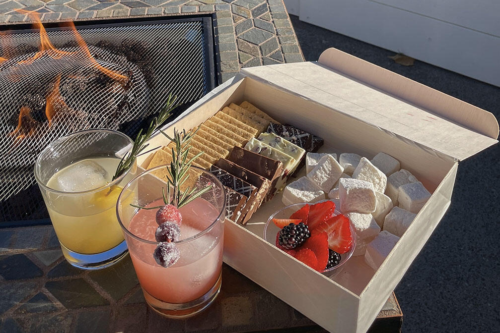 colorful drinks sit next to a box containing S'more makings