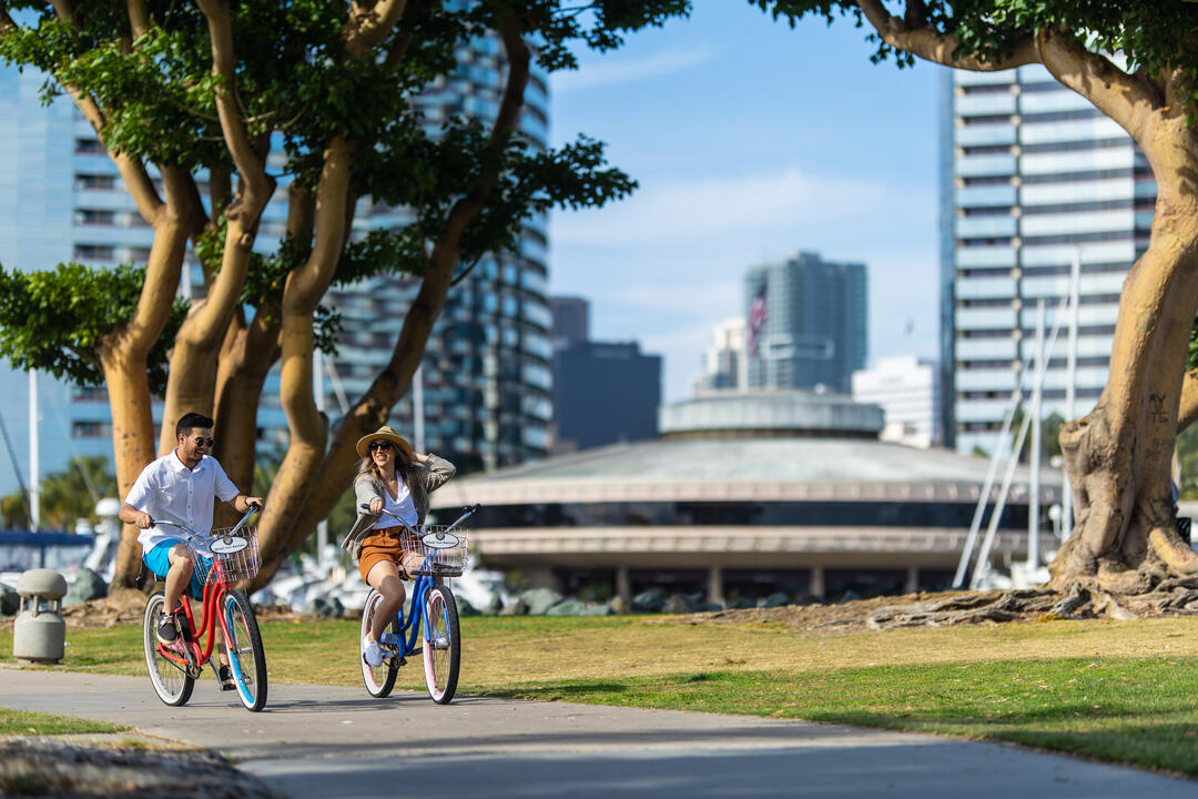 a couple ride bikes along ta path at Embarcadero North