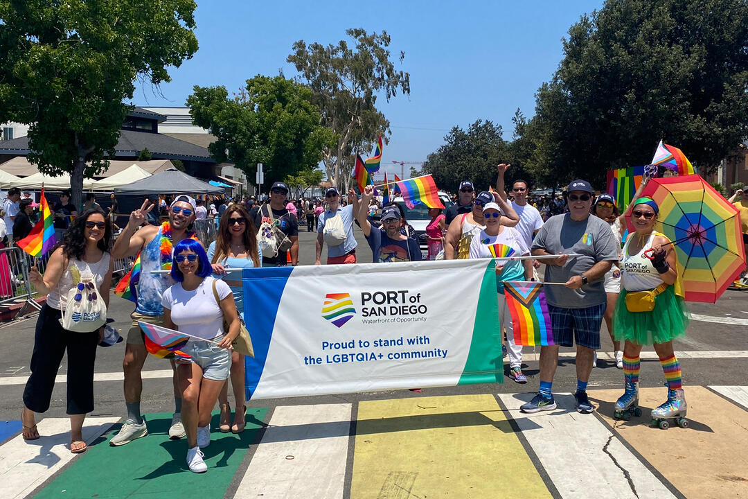 Port staff at San Diego Pride Parade holding a Port Pride banner.