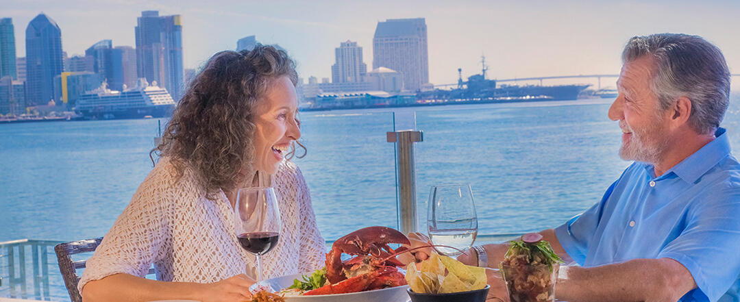 Couple enjoying dinner and the San Diego skyline from Harbor Island