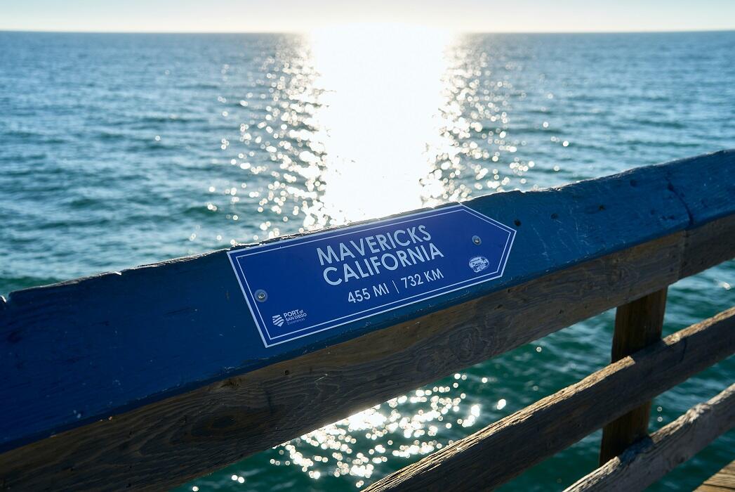 Blue sign in the shape of an arrow points to famed surf destination Mavericks, California, 455 miles from Imperial Beach.