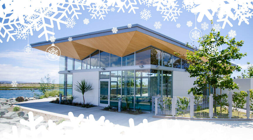 Image of the Port Aquatic Center on the National City Bayfront with snowflake graphics against a blue sky.