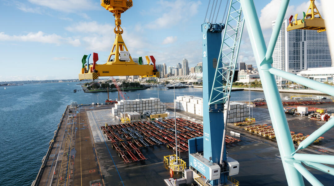 a view froma a crane of cargo being lifted 