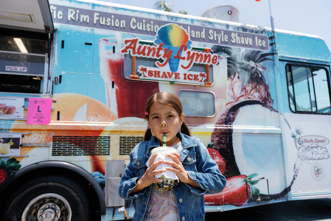 A little girl enjoys a snack 