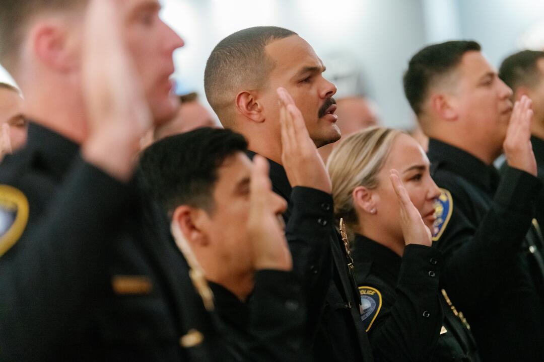 New Harbor Police officers hold up their hand to be sworn in