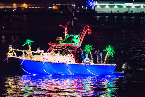 A pleasure boat with holiday lights.