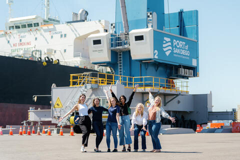Left to right: Natalia Jimenez, IT Business Partner; Michelle Giron, Senior Environmental Specialist; Lisa Madsen, Senior Planner; Sureena Basra, Senior Planner; Maggie Weber, Principal in Strategic Planning; and Renée Yarmy, Program Director in Maritime Sustainable Development pose in front of one of the Port's all new mobile harbor electric cranes.