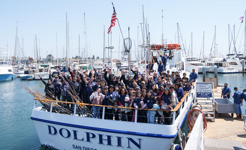 Harbor Police and other law enforcement agencies with Perkins K-8 kids on the Dolphin vessel for Fish with a Cop