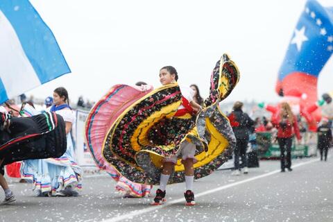 A young dancer walks in holiday parade.