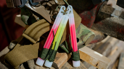 Toxic free, biodegradable glow sticks. There are three sticks a pink stick yellow stick and then another pink stick.