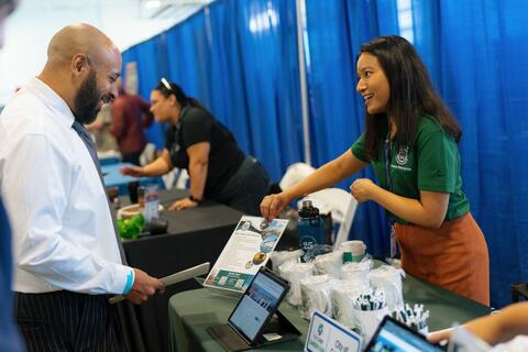 Woman showing a flyer to a man