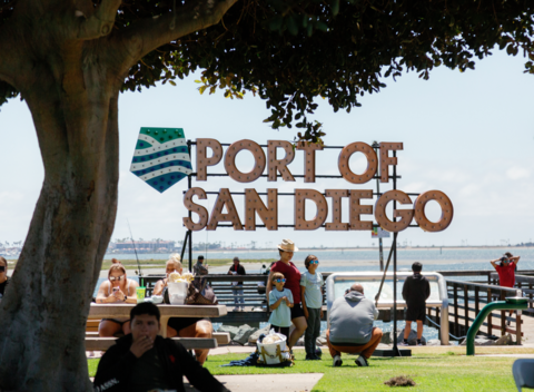 Port of San Diego sign and people at park