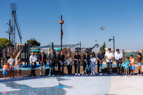 Port officials and National City officials cut a light blue ribbon