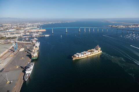 Cargo ship in San Diego Bay with Coronado Bridge in background.