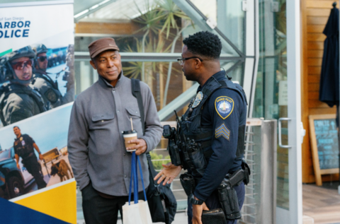 Port of San Diego Harbor Police officer and member of public talk over a cup of coffee