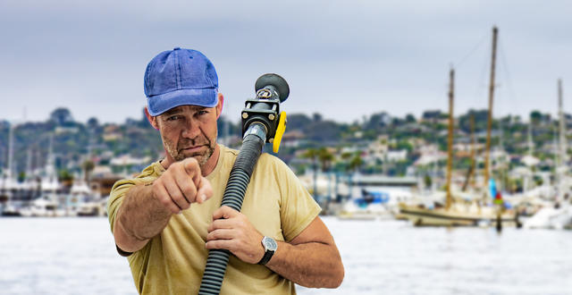 a person is holding a pump out hose and pointing at the viewer