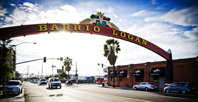 a partially cloudy day photo of the Barrio Logan Gateway sign