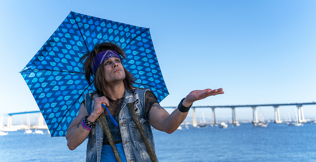 Rocker Storm Drayne Is ready for rain with his umbrella!