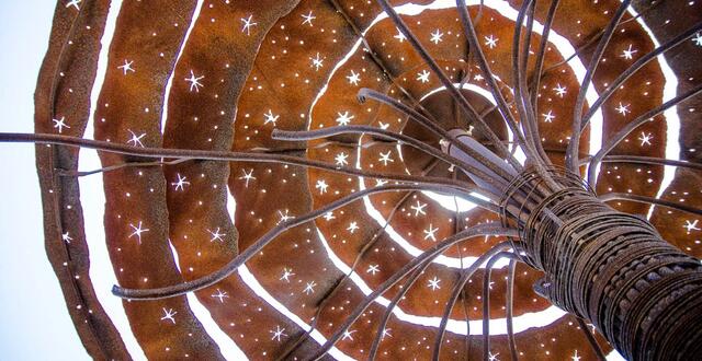looking skyward through a rusty metal spiral