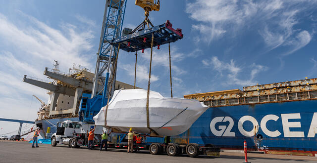 a cargo ship unloads a boat at the Port of San Diego