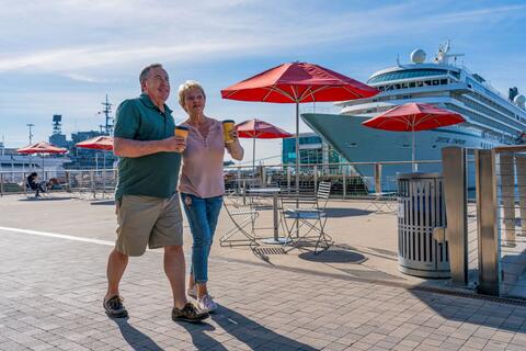 Couple walking with coffee along Embarcadero