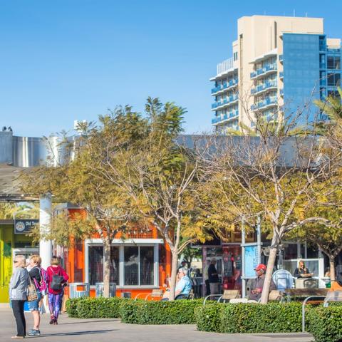 Vendors near trees and sitting area at Broadway Plaza at the Port of San Diego