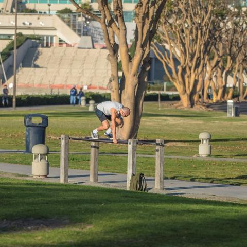 Man working out at the exercise station at Embarcadero Marina Park South at the Port of San Diego