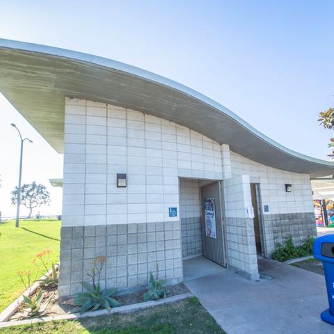 Restroom with white and gray tiled exterior and curvilinear roof at Pepper Park at the Port of San Diego