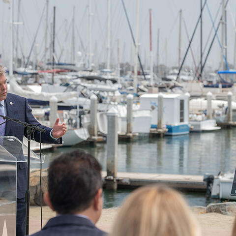 Commissioner Malcolm speaking with the Chula Vista Bayfront behind him