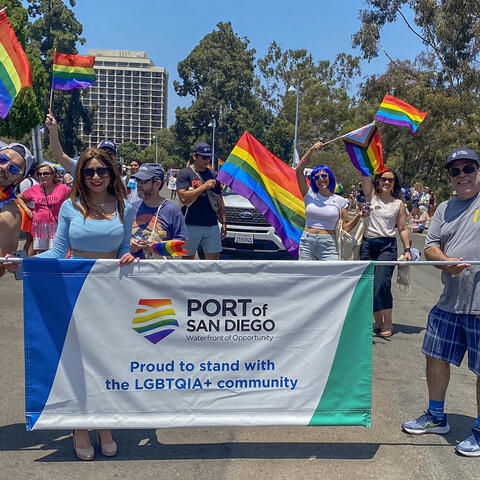 Port staff at San Diego Pride Parade holding a Port Pride banner.