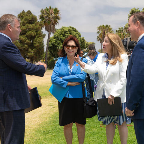 Port Commissioners and elected officials chat in a park