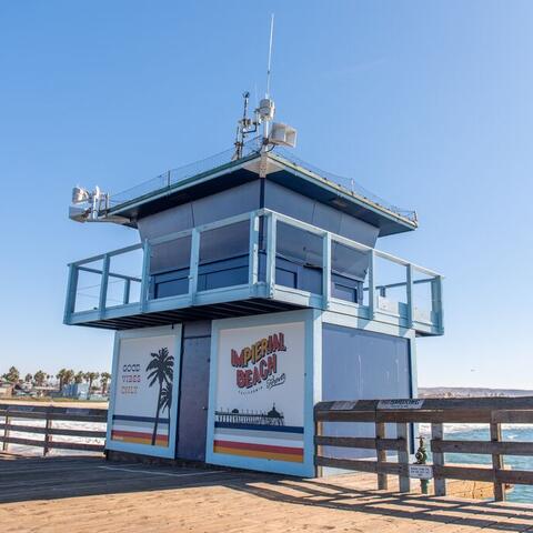 Colorful mural on the lifeguard tower on the Imperial Beach Pier that says "Good vibes only" and "Imperial Beach."