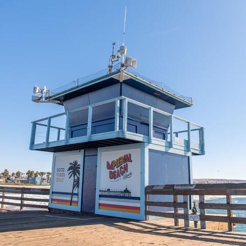 Colorful mural on the lifeguard tower on the Imperial Beach Pier that says "Good vibes only" and "Imperial Beach."