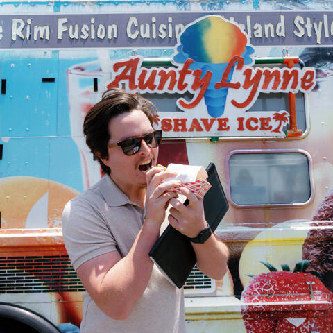 A cool guy in sunglasses enjoys a snack