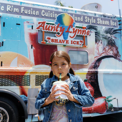 A little girl enjoys a snack 
