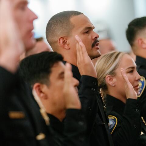 New Harbor Police officers hold up their hand to be sworn in