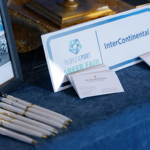 2024 People of the Port Career Fair Booth Detail with business cards, pens, and name tags