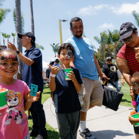 Kids with painted faces smile 